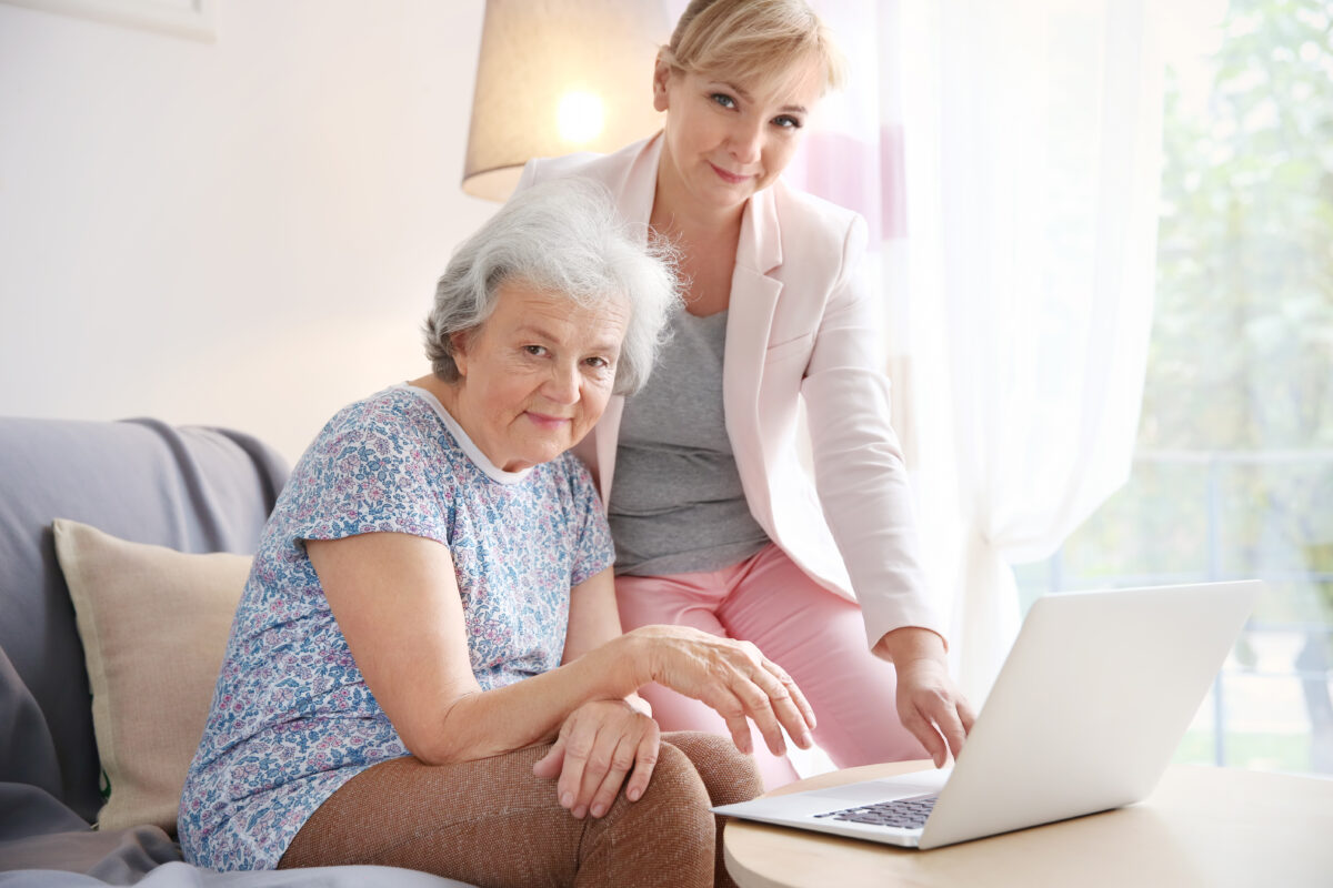 Daughter with elderly mother and laptop